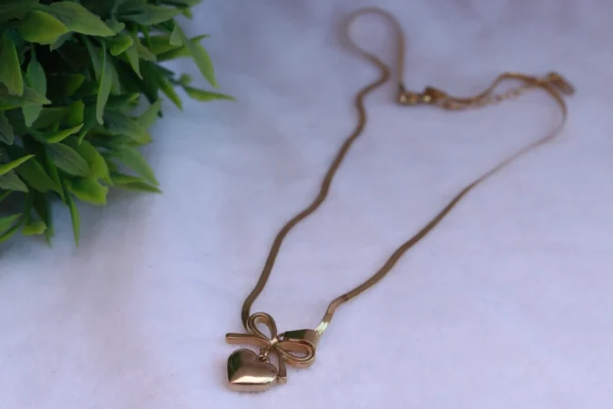 Gold Tone Snake Chain Necklace with Bow and Heart Pendant