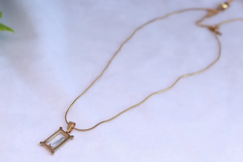 Gold Tone Snake Chain Necklace with Rectangular Clear Stone Pendant