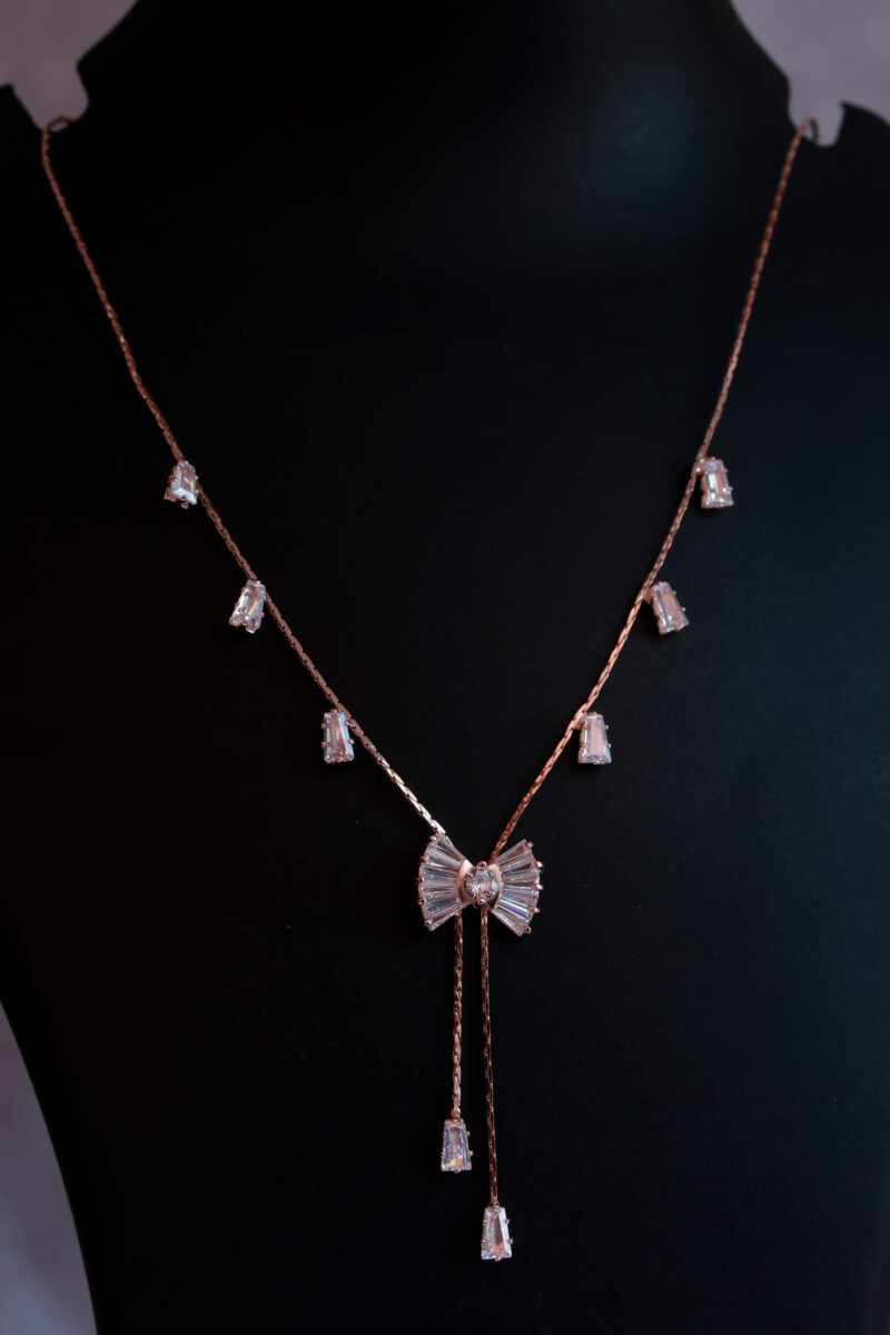 Rose Gold Tone Necklace with Sparkling Bow and Dangle Accents - Image 2